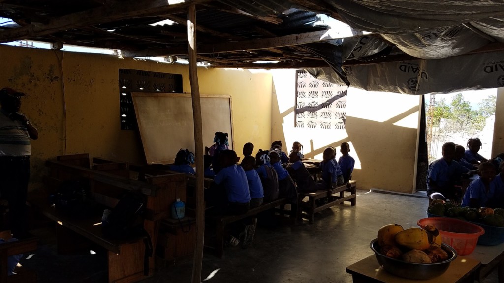 Haiti school with partial roof from hurricane damage.